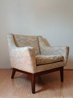 Front view of R Huber teak lounge chair