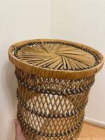 Side view showing cylindrical rattan stand, lattice weave and radial top pattern