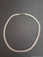 Full view of the 20-inch silver herringbone chain formed in a circle