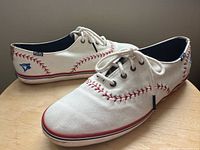 Side view showing full pair, uppers, stitching and laces