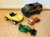 All four Tonka vehicles grouped on floor