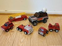 All six Buddy L vehicles with golf ball for scale