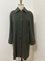 Front view of forest green cashmere wool blend coat on dress form