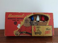 Front of box showing Universal Decorative Christmas Light Set with three bulb colours visible