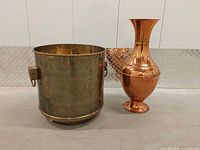 Brass planter and copper urn side by side