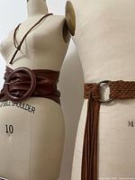 Front view showing wide leather belt on size 10 form and braided belt with ring buckle on size 40 form