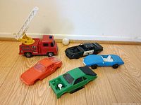 Group shot of five plastic model vehicles on floor