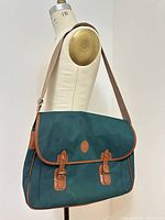 Full view of Polo Ralph Lauren green canvas messenger bag on mannequin