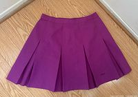 Front view of violet purple pleated tennis skirt