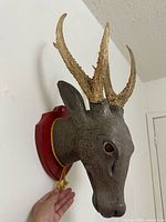 Left side view showing resin head, real antlers, red base