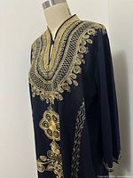 Closeup of upper embroidery around neckline and chest