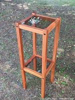 Full view of teak two-tier stand outdoors