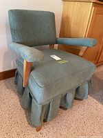 Full view of upholstered arm chair showing design and condition