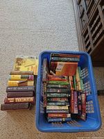 Overall view of basket full of books and separate hardcover stack