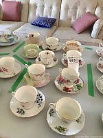 Top view of multiple floral teacup and saucer pairs