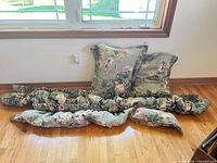 Two pillows stacked against wall with two ruffled valances laid out