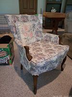 Front view of floral armchair with pillow