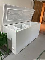 Chest freezer lid open showing interior and baskets