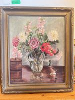 Front view of framed V. Elliott acrylic floral still life painting