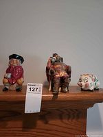 Overall view of three ceramic pieces on shelf