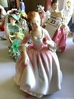 Front angled view of Royal Doulton Tender Moment figurine showing face, bodice, and skirt colours
