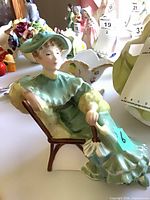 Front view of Royal Doulton Ascot figurine seated in chair