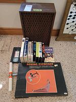 All items grouped: speaker, VHS tapes, rowing exerciser box and handle