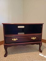 Front view showing open shelf, drawer, legs, hardware