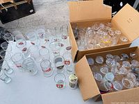 Overview of table and two boxes showing numerous branded glasses