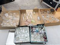 Overview of all boxes and tins containing assorted glassware
