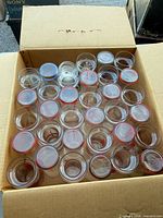 Open box showing 30 identical cocktail glasses