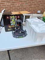 Statue, box, styrofoam insert on table