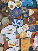 Overall view of mixed ashtrays, trays and dishes spread on table