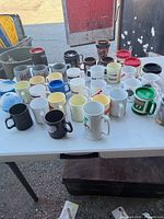 table showing entire assortment of plastic mugs in rows