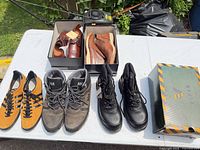 All five pairs of shoes and boots displayed on table