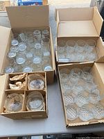 Four boxes showing assorted glassware types and quantities