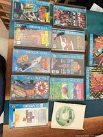 Overview of twelve Sega CD items laid out, titles visible