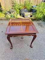 Full view of square mahogany-stained side table showing inlaid top and cabriole legs