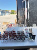 Full lot on table showing McDonald's, Coca-Cola and beer glasses