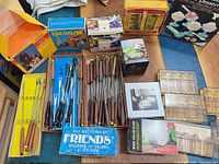 Overview of lot showing fondue forks, boxed gadgets, Friends salt & pepper set and spice racks