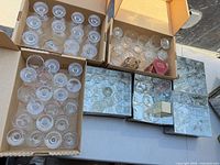 Multiple boxes of assorted clear glass drinkware