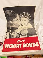 Full poster front showing soldier and child with red BUY VICTORY BONDS banner