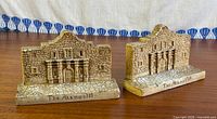Front view of both Alamo bookends showing façade details and inscription