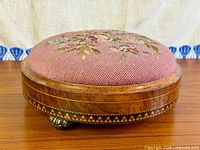 side view showing needlepoint top, walnut frame and inlay