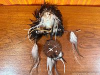 Front view of feathered leather wall hanging