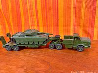 Full view of Mighty Antar tractor with trailer carrying tank