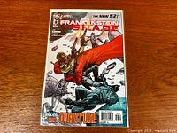 Full view of bagged and boarded comic showing cover art and signature