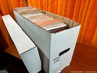 Long cardboard longbox filled with bagged comics