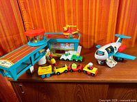 Full view of terminal, airplane, helicopter, vehicles, trailers and figures