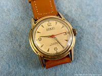 Front view of Crest wristwatch showing dial and strap
